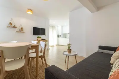 a living room with a table and a dining room at Allo Apartments Morenos I 2ºC Centro 1 habitación in Jerez de la Frontera