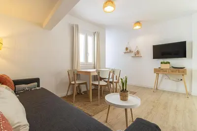 a living room with a couch and a table at Allo Apartments Morenos I 2ºC Centro 1 habitación in Jerez de la Frontera