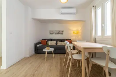 a living room with a table and a couch at Allo Apartments Morenos I 2ºC Centro 1 habitación in Jerez de la Frontera