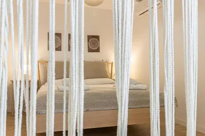 a bed with white curtains in a room at Allo Apartments Morenos I 2ºC Centro 1 habitación in Jerez de la Frontera