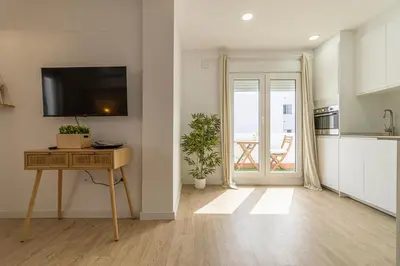 a kitchen with a table and a television in a room at Allo Apartments Morenos I 2ºC Centro 1 habitación in Jerez de la Frontera