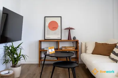 a living room with a table and a couch at La Casa Bonita de la Victoria Livework By Cadiz Time in Cádiz