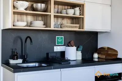 a kitchen with a sink and a counter with dishes at La Casa Bonita de la Victoria Livework By Cadiz Time in Cádiz