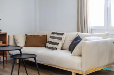a white couch with pillows on it in a living room at La Casa Bonita de la Victoria Livework By Cadiz Time in Cádiz