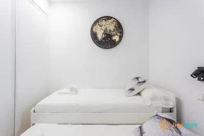 a room with white walls and a clock on the wall at Cádiz Living by LiveWork in Cádiz