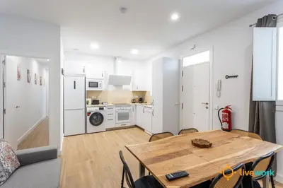 a kitchen and dining room with a table in a room at Cádiz Living by LiveWork in Cádiz