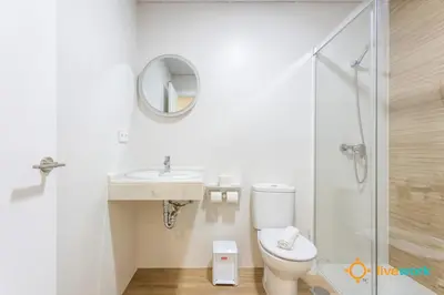 a bathroom with a toilet and a sink and a mirror at Cádiz Living by LiveWork in Cádiz