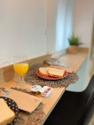 a table with bread and a glass of orange juice at Loft Mamalú Jerez in Jerez de la Frontera