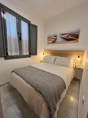 a living room with a bed and a couch at Casa Palacio Caballeros in Sanlúcar de Barrameda
