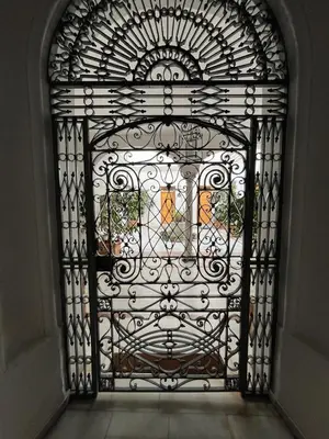 an iron gate with a window in a building at Casa Palacio Caballeros in Sanlúcar de Barrameda