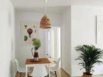 a dining room with a table and two chairs at Apartamento Residencial Arcos in Jerez de la Frontera