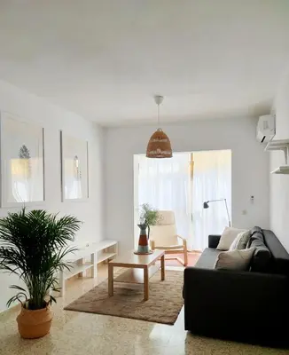 a living room with a couch and a table at Apartamento Residencial Arcos in Jerez de la Frontera