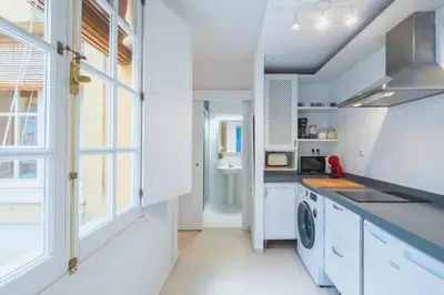 a kitchen with white cabinets and a sink at Cadizz Anda La Luz Tu lugar en El Puerto Santa María centro ciudad in El Puerto de Santa María