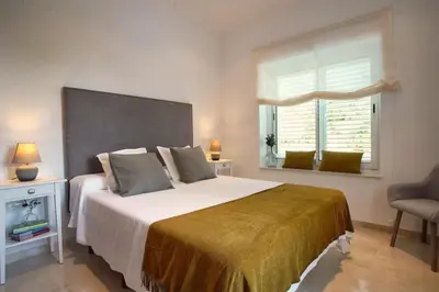 a bedroom with a large bed and a window at Villa 211 by Villamya in Vallejas