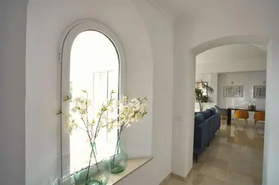 a living room with a blue couch and a vase with flowers at Villa 211 by Villamya in Vallejas
