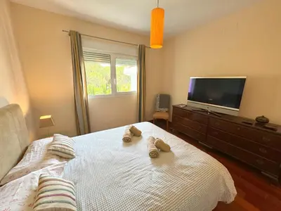a bedroom with a bed with two slippers on it at Villa el Cenador, Urb Roche Conil in Roche