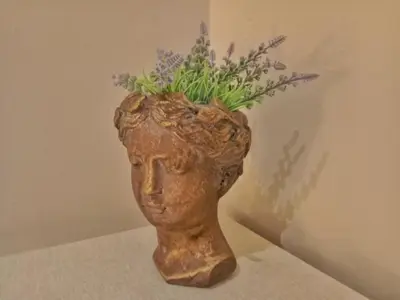 a statue of a head with flowers in it at Casa Remedios in Jerez de la Frontera