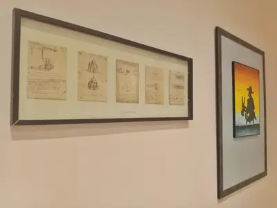 a picture hanging on a wall with a picture at Casa Remedios in Jerez de la Frontera