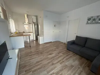 an empty living room with a couch and a kitchen at casa comoda sanluca in Monte Olivete