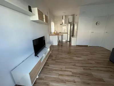 a living room with a flat screen tv on a wall at casa comoda sanluca in Monte Olivete