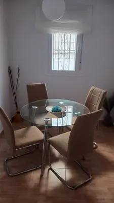 a dining room with a glass table and chairs at casa andaluza 109 in Novo Sancti Petri