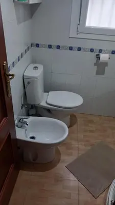 a bathroom with a toilet and a sink at casa andaluza 109 in Novo Sancti Petri
