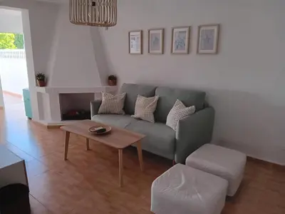 a living room with a couch and a coffee table at casa andaluza 109 in Novo Sancti Petri