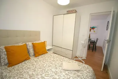 a bedroom with a large bed with orange pillows at Buleria in Jerez de la Frontera
