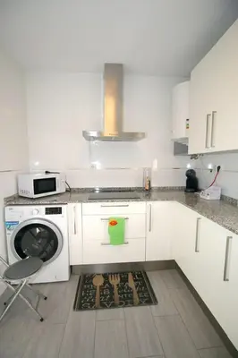 a kitchen with a washing machine and a stove at Buleria in Jerez de la Frontera