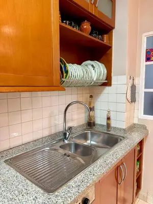 a kitchen counter with a sink in a kitchen at Grand Beachfront Apartament - Cadiz in Cádiz