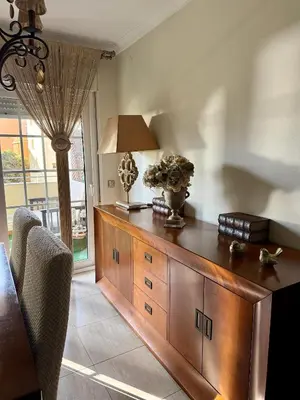 a wooden cabinet in a room with a window at Grand Beachfront Apartament - Cadiz in Cádiz