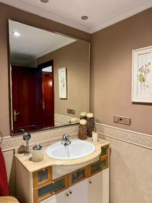 a bathroom with a sink and a large mirror at Grand Beachfront Apartament - Cadiz in Cádiz