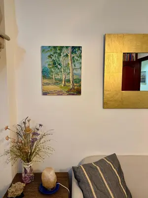a living room with a couch and a painting on the wall at Grand Beachfront Apartament - Cadiz in Cádiz