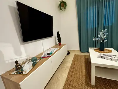 a living room with a flat screen tv on a wall at Apartamento MAREMIA in San Fernando