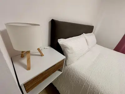a bedroom with a bed and a lamp on a night stand at Apartamento MAREMIA in San Fernando