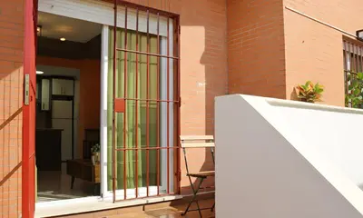 a glass door with green bars on a building at Apartamento La Venencia II in Jerez de la Frontera