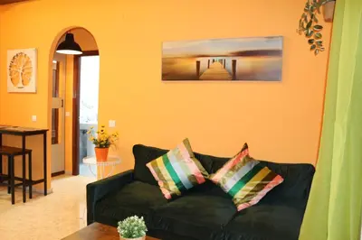 a living room with a black couch and a table at Apartamento La Venencia II in Jerez de la Frontera