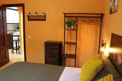 a bedroom with a bed and a dresser at Apartamento La Venencia II in Jerez de la Frontera