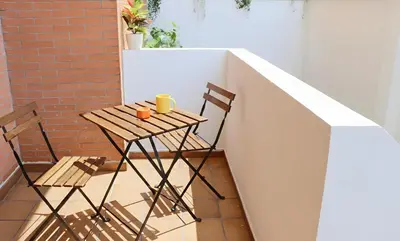 a small table and two chairs on a balcony at Apartamento La Venencia II in Jerez de la Frontera