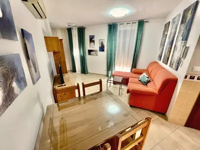 a living room with an orange couch and a table at Loft 41 en Algar by Villamya in Algar