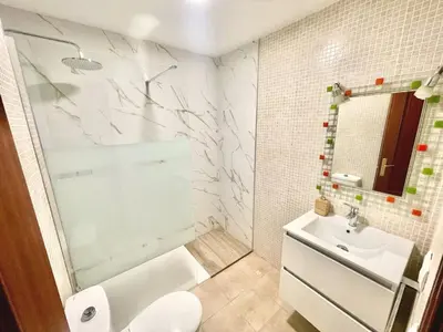 a bathroom with a shower and a toilet and a sink at Loft 41 en Algar by Villamya in Algar