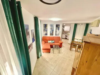 a living room with an orange couch and a table at Loft 41 en Algar by Villamya in Algar