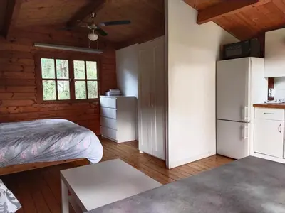 a small room with a bed and a refrigerator at Cabañas de Veròn in Conil de la Frontera