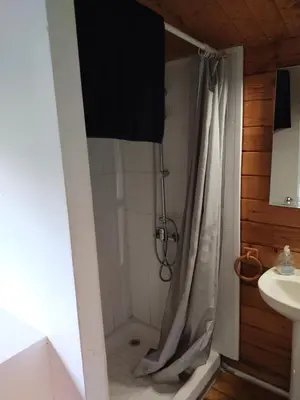 a bathroom with a shower curtain and a sink at Cabañas de Veròn in Conil de la Frontera