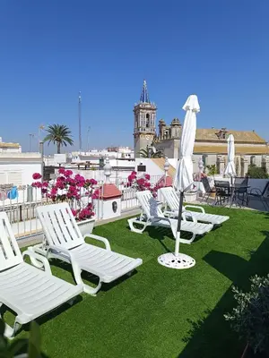 a swimming pool with a stair in a building at Apartamentos turísticos CASA de los BALCONES in Chipiona