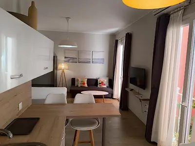 a living room with a table and chairs and a couch at Apartamentos turísticos CASA de los BALCONES in Chipiona