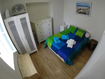 a small bedroom with a bed and a dresser at DescubreHome Sacramento in Cádiz