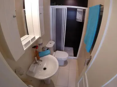 a bathroom with a sink and a toilet and a shower at DescubreHome Sacramento in Cádiz