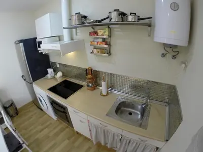 a small kitchen with a sink and a counter at DescubreHome Sacramento in Cádiz