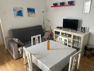 a living room with a table and a couch at DescubreHome Sacramento in Cádiz
